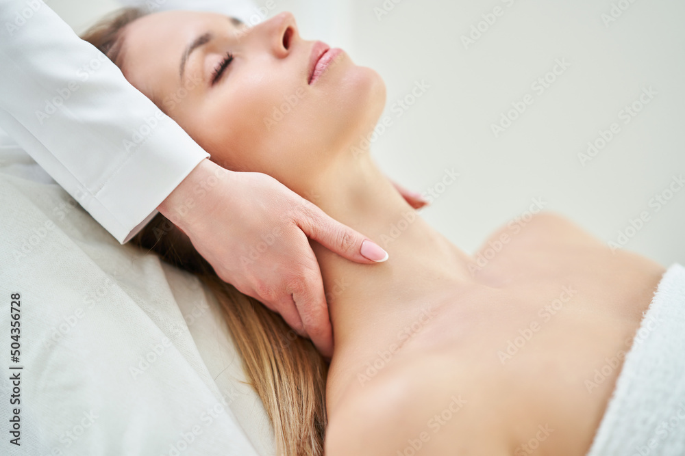 Young nice woman having face massage in spa Young nice woman having face massage in spa