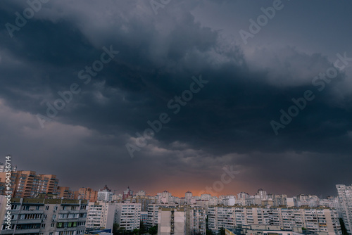 Dramatic dark stormy sky over modern city residential district.