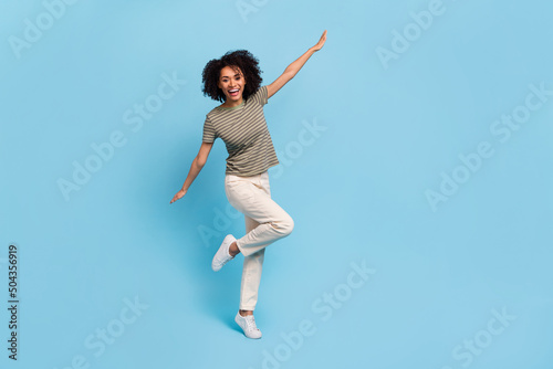 Full size photo of excited lovely lady holding hands like flying bird isolated on sky light color background © deagreez