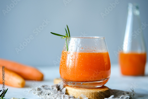 Carrot juice in a glassy glass. Freshly lived carrot juice. Orange carrot juice. Vegetable juice
