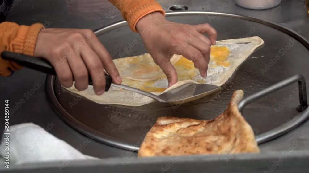Making traditional Indian food called 'Roti Canai', slow motion
Making traditional Indian food called 'Roti Canai', slow motion