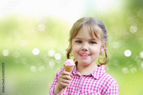 Caucasian toddler girl eating ice cream. Portrait of child with ice-cream.Summer season.