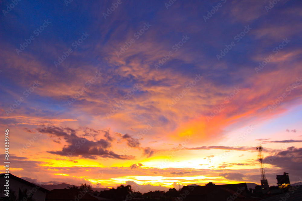 Colorful Sunset. Gorgeous Panorama Twilight Sky. Cloudy Rose Blue Sunset over Dark Silhouettes