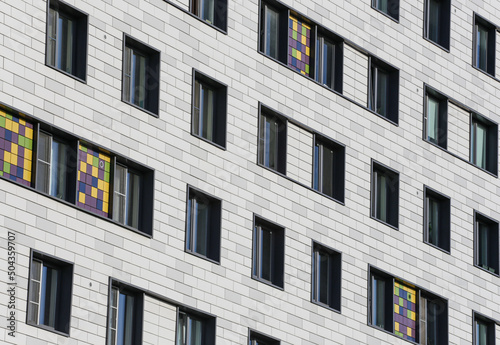 Urban landscape with the facade of a residential building. Modern European residential apartment building. Apartment building with modern architecture. Aluminum composite panels in a modern building.