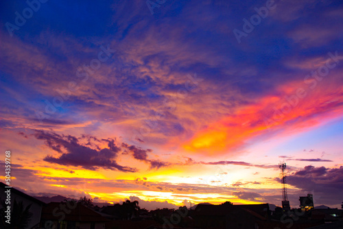Colorful Sunset. Gorgeous Panorama Twilight Sky. Cloudy Rose Blue Sunset over Dark Silhouettes