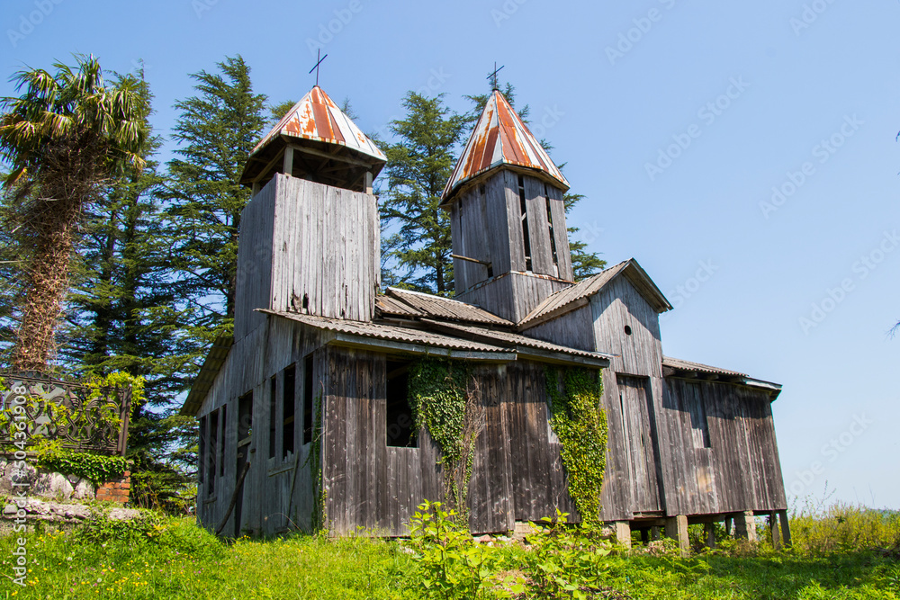 Old wooden Georgian church in Georgia. Old architecture and nature.