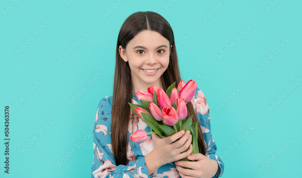 teen girl with spring bouquet on blue background. floral present. happy child with tulips.