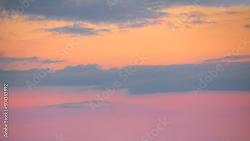 Pink orange sky with clouds at beautiful sunset as natural background.