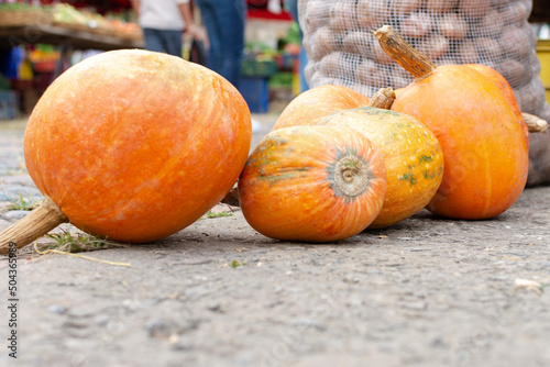 Pumpkins laid out on the ground in a traditional Latin American market