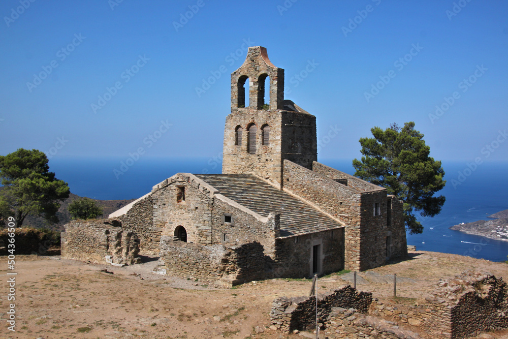 The romanesque church of Santa Helena de Rodes with its bell tower at the Mediterranean Sea in Catalonia, Spain
