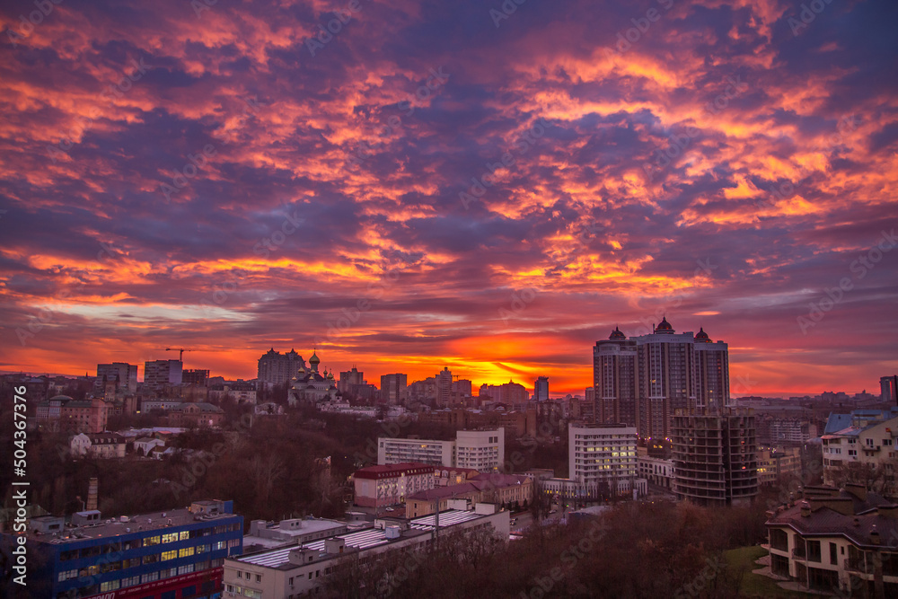 Fototapeta premium Ukraine, Kyiv – November 26, 2016: Aerial panoramic view on central part of Kyiv city, residential area at sunset. Stunning sunset, golden hour. Lukianivska area. City silhouettes. 