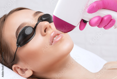 Elos epilation hair removal procedure on a woman’s body. Beautician doing laser rejuvenation in a beauty salon. Removing unwanted body hair. Hardware ipl cosmetology
