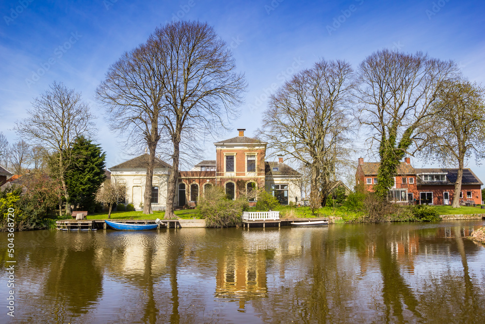 Historic houses at the Winsumerdiep river in Onderdendam, Netherlands