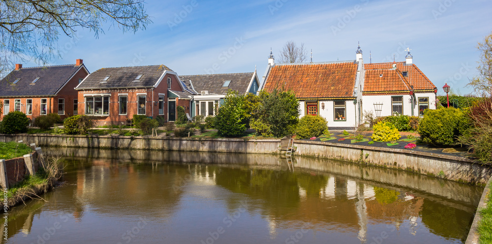 Panorama of historic houses at the canal in Middelstum, Netherlands Panorama of historic houses at the canal in Middelstum, Netherlands