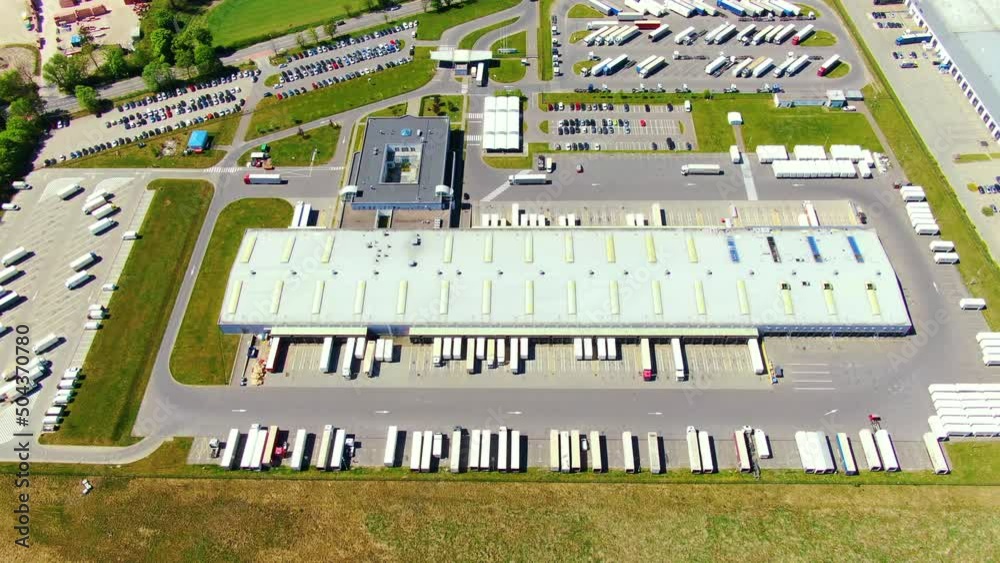 Aerial view of warehouse storages or industrial factory or logistics center from above. Top view of industrial buildings and trucks Aerial view of warehouse storages or industrial factory or logistics center from above. Top view of industrial buildings and trucks