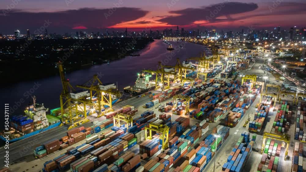 Hyper lapse time-lapse of shipping port, cargo container ship, crane, and car traffic in Asia city at night sunset. Logistic industry or freight transportation business concept, drone aerial view