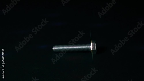metal bolt rotate on a dark background