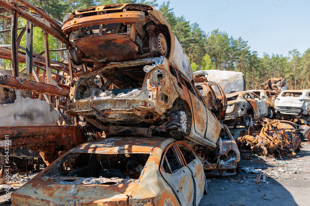 Many shot and destroyed cars at the car graveyard in Irpin, Ukraine.