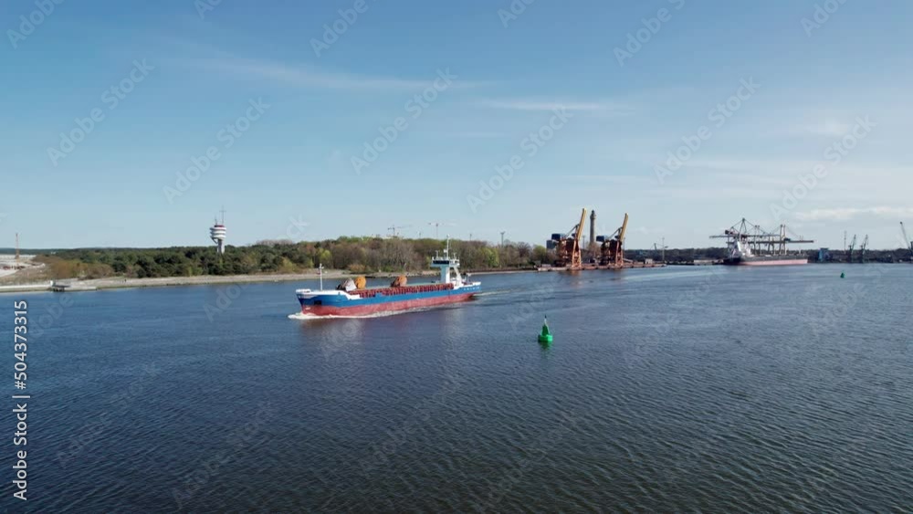 An aerial view of a cargo ship leaves the port. An aerial view of a cargo ship leaves the port.