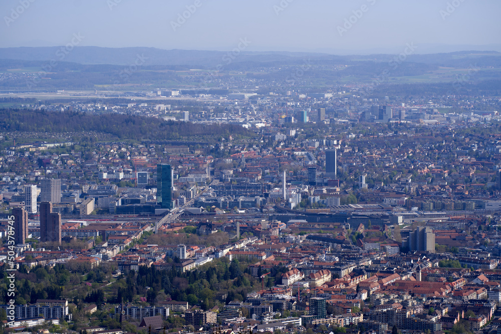 Panoramic view from local mountain Uetliberg over City of Zürich on a blue cloudy spring day. Photo taken April 14th, 2022, Zurich, Switzerland.