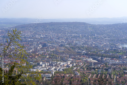 Fototapeta Naklejka Na Ścianę i Meble -  Panoramic view from local mountain Uetliberg over City of Zürich on a blue cloudy spring day. Photo taken April 14th, 2022, Zurich, Switzerland.