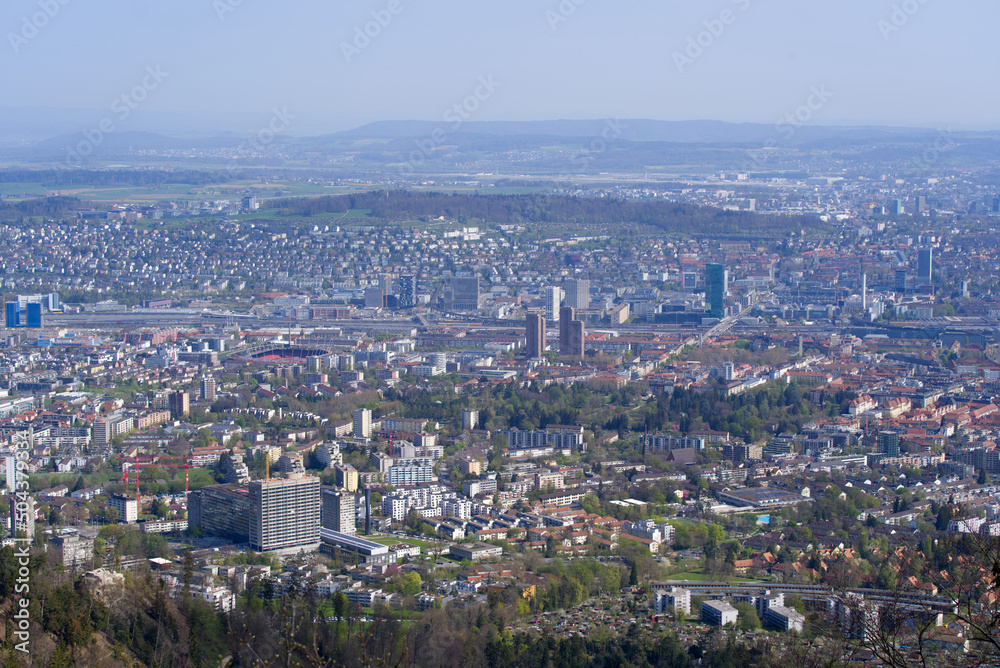 Panoramic view from local mountain Uetliberg over City of Zürich on a blue cloudy spring day. Photo taken April 14th, 2022, Zurich, Switzerland.