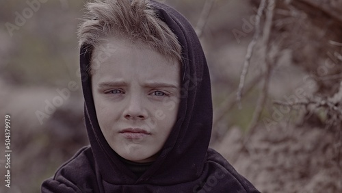 A boy walks among cut down trees. Russia. photo