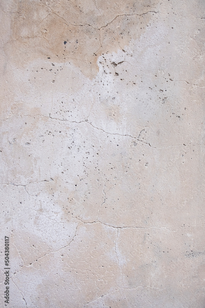 Fototapeta premium Beige wall with cracks. Wall of the house. Home repairs. Construction. Texture and background