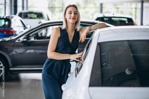Young business woman looking for a car to buy