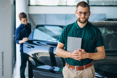 Man buying a car in a car showroom