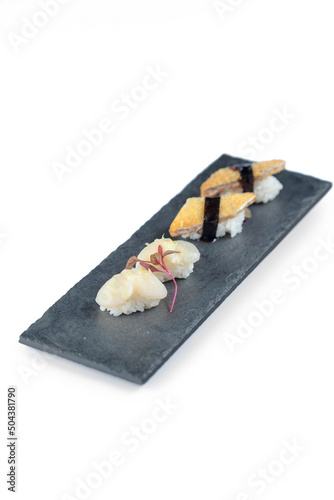 sushi rolls with rice and fish, soy sauce on stone 