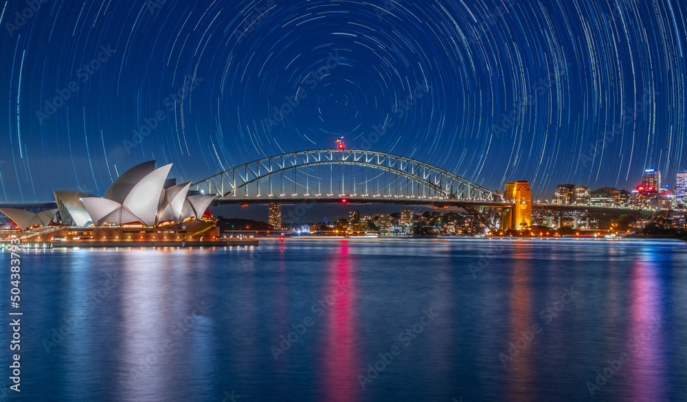 Obraz premium Star trails in the sky over Sydney Harbour NSW Australia startrails. lovely patterns and beautiful colours of the night.