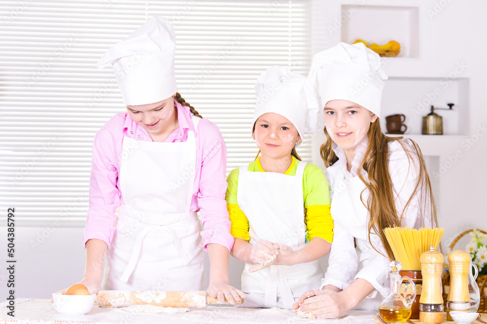 Portrait of three girls cooking on kitchen Portrait of three girls cooking on kitchen