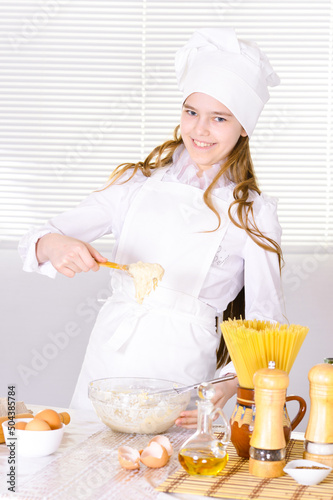 Portrait of cute girl cooking in the kitchen