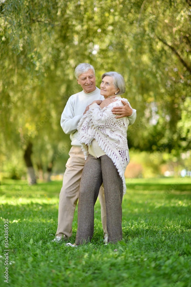 Portrait of senior couple walking in autumn forest