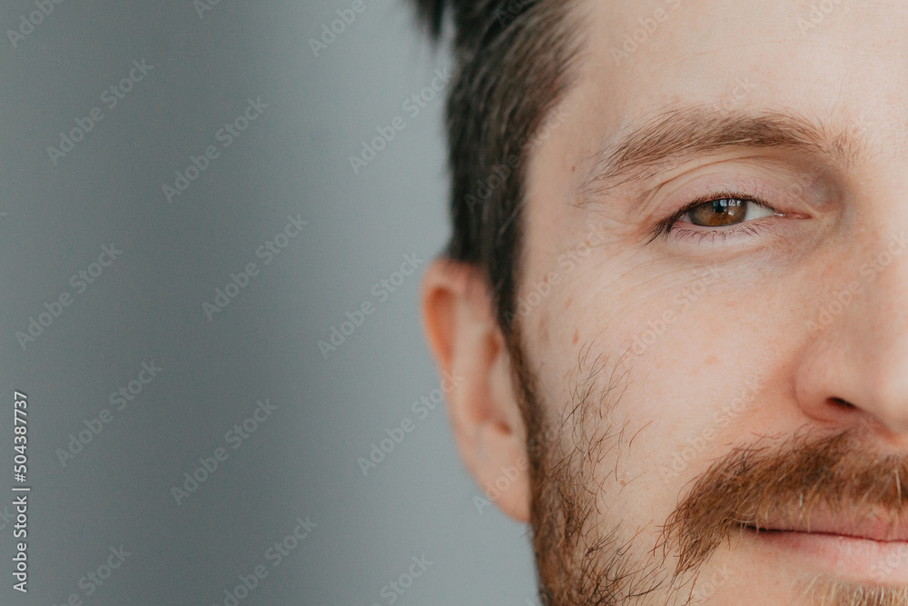 Close-up of the face of a handsome young man with brown eyes Close-up of the face of a handsome young man with brown eyes