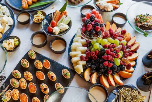Various appetizers on the festive table. Shallow depth of field.