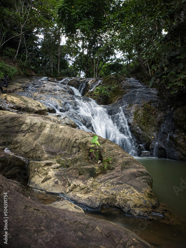 giant rock rim surrounds the waterfall in Pinang Seribu Samarinda
