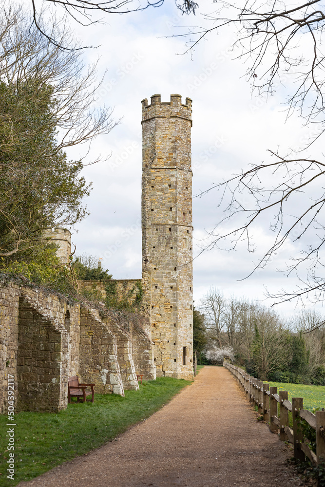 Tall cream stone tower at the end of a wall