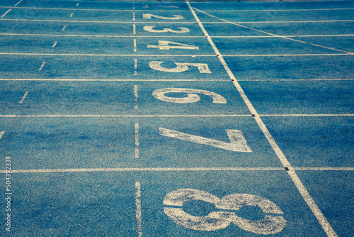Blue treadmill at the stadium with the numbering from one to eight 
