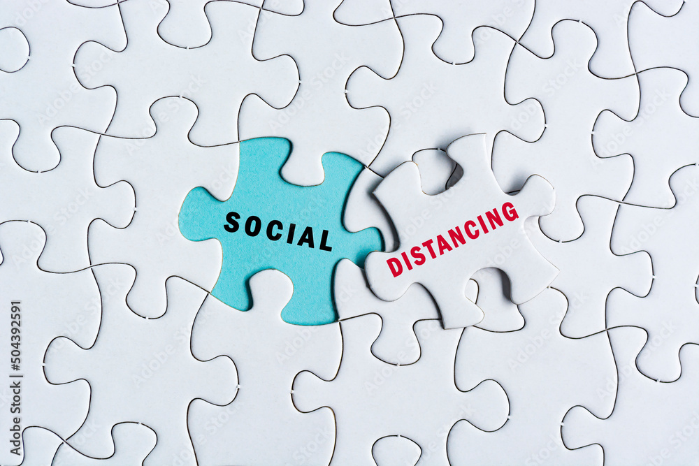 Social distancing text on Jigsaw Puzzle. Pandemic concept Social distancing text on Jigsaw Puzzle. Pandemic concept