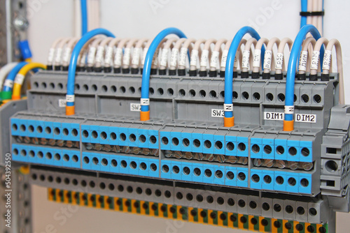 Electrical terminals with connected colored mounting wires in the control panel.