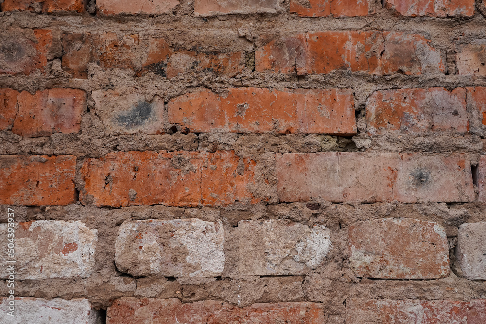 Red brick wall background with cracks between bricks Red brick wall background with cracks between bricks