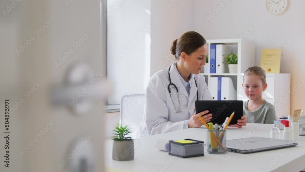 medicine, healthcare, pediatry and people concept - female doctor or pediatrician showing tablet computer to little girl patient at clinic medicine, healthcare, pediatry and people concept - female doctor or pediatrician showing tablet computer to little girl patient at clinic