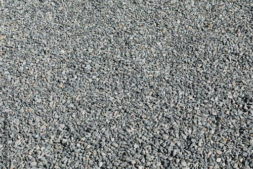 Sidewalk only with compacted crushed stone, in a regular and flat manner.