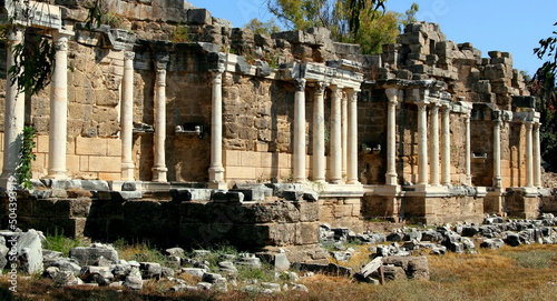 Side view of the ruins of the ancient Roman fountain Nymphaeum with snow-white columns in the historic part of Side, near Antalya, Turkey 