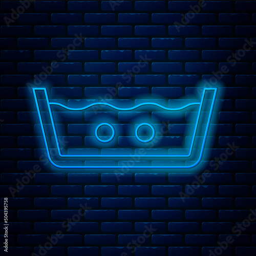Glowing neon line Washing under 40 degrees celsius icon isolated on brick wall background. Temperature wash. Vector