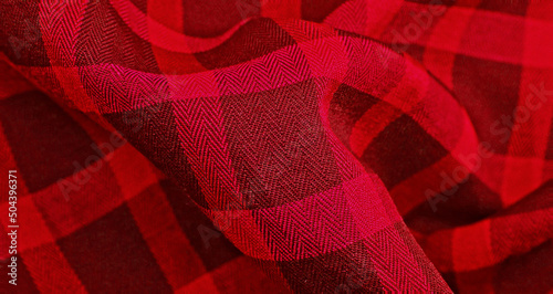 Red Clothes backdrop. Background luxury red wavy cloth. Wavy folds of grunge silk texture satin velvet clothing, luxurious background or elegant wallpaper