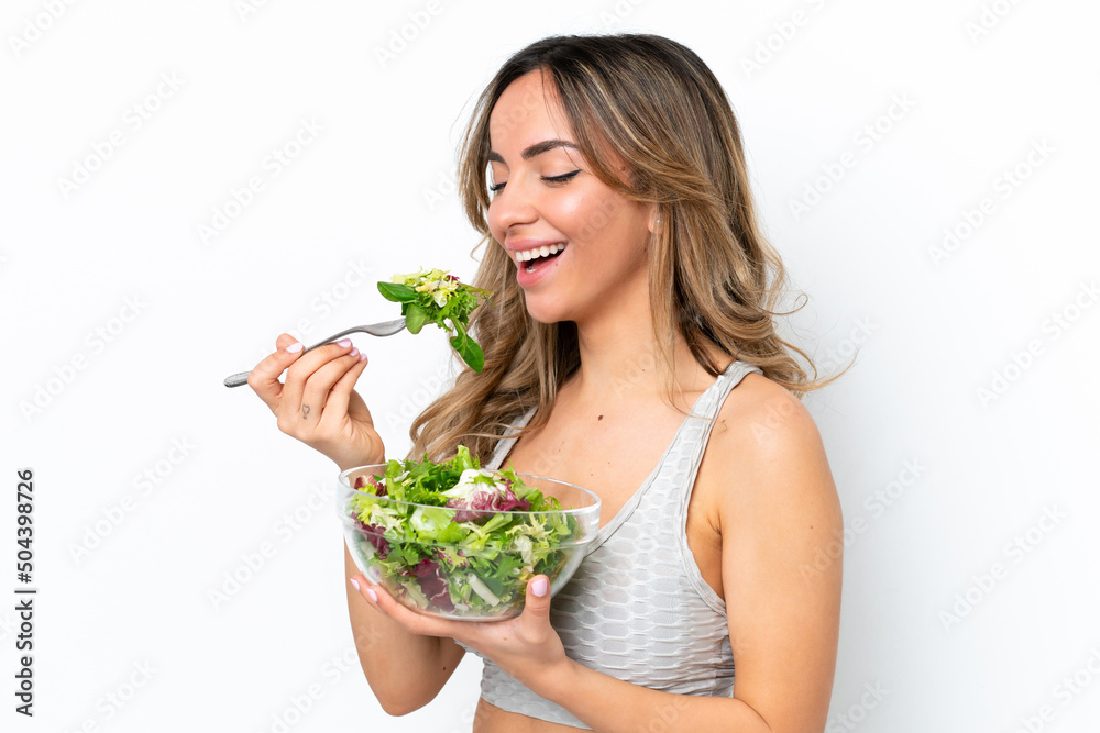 Young caucasian woman isolated on white background holding a bowl of salad with happy expression Young caucasian woman isolated on white background holding a bowl of salad with happy expression