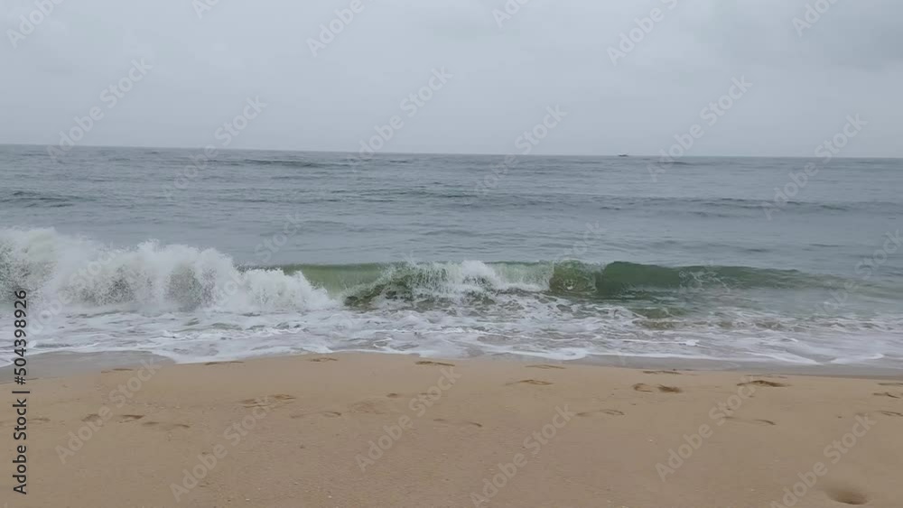 waves crashing in to the beach a view from Arthunkal beach kerala India waves crashing in to the beach a view from Arthunkal beach kerala India